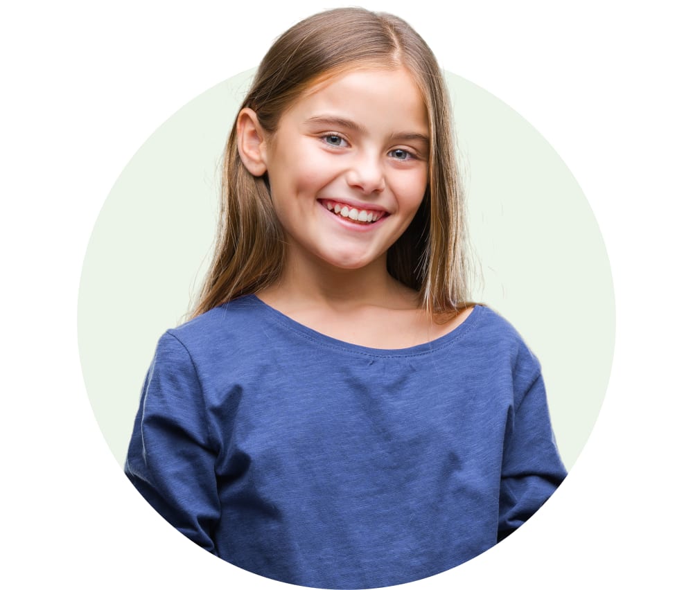 A young girl with blonde hair and blue eyes is smiling.